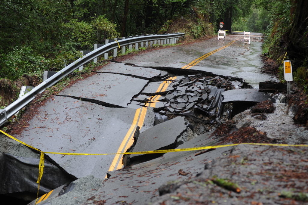 A view of a split open road in a forest after storm and heavy rain in the Santa Cruz Mountains above Silicon Valley in Scotts Valley, California, United States on January 09, 2023