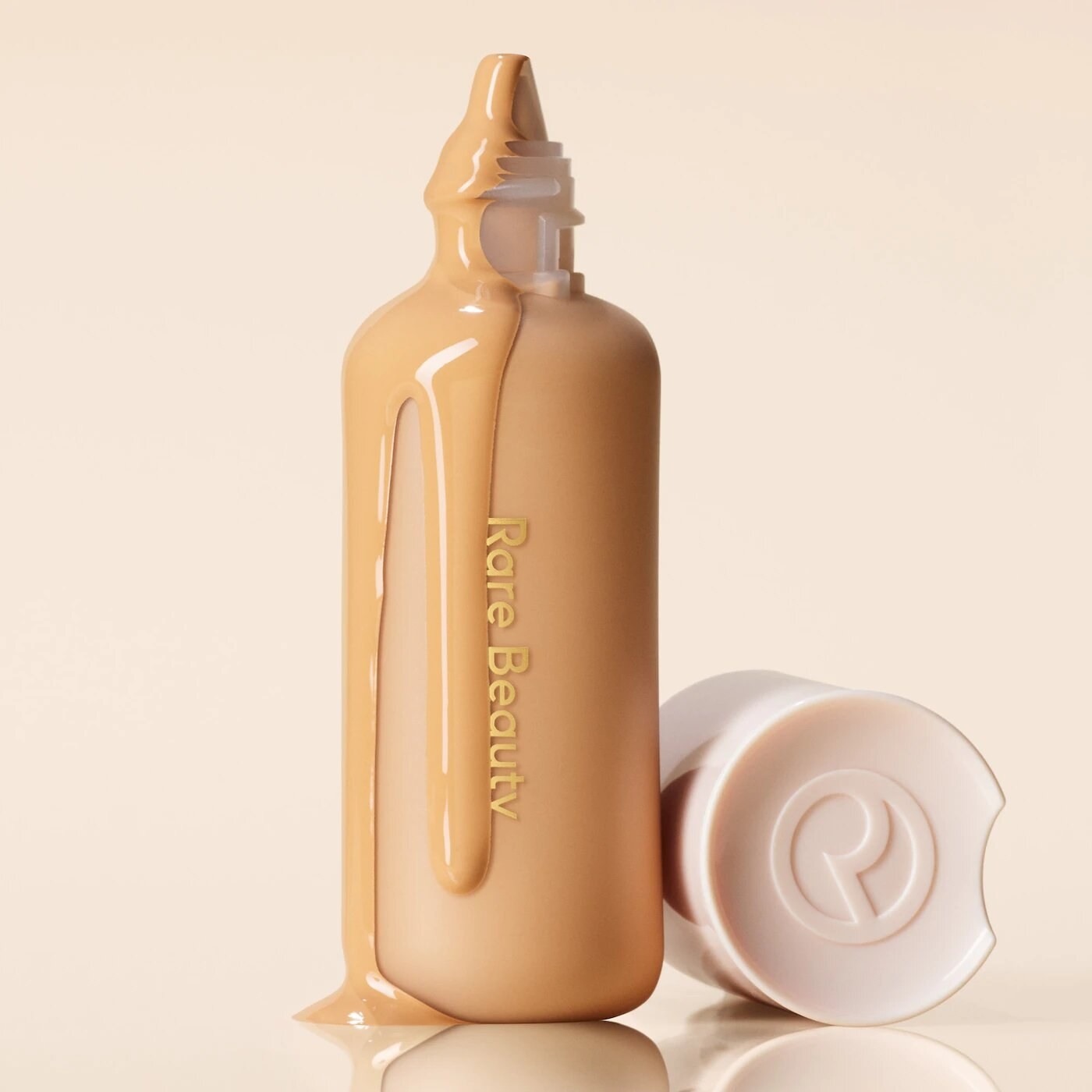 the tinted moisturizer with the lid off and the product dripping out and down the bottle