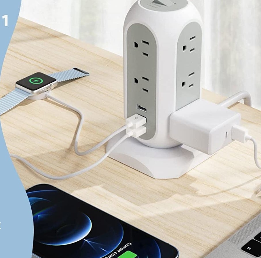 The power bar on a desk with some chargers plugged in