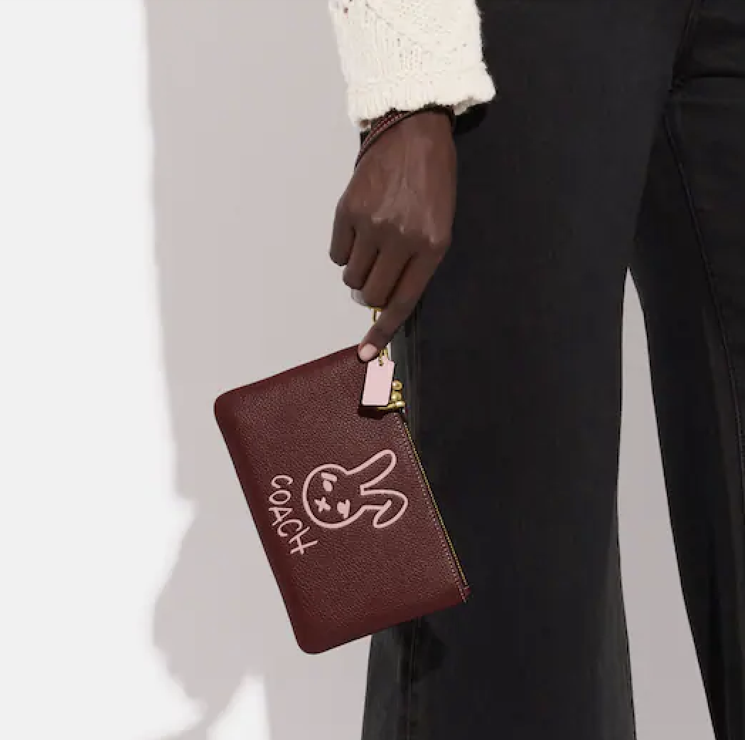 person holding the wristlet
