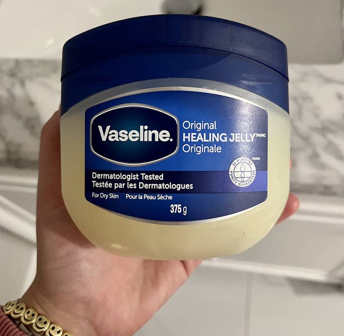 Melina holding a tub of vaseline