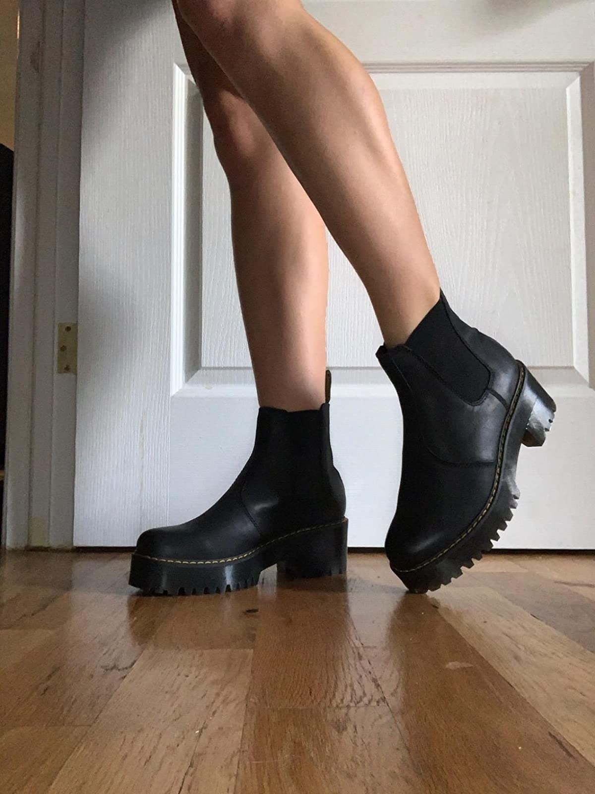 reviewer wearing the black boots