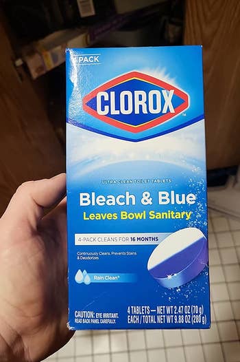 a reviewer holding a box of the clorox tablets
