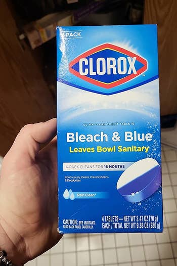 a reviewer holding a box of the clorox tablets