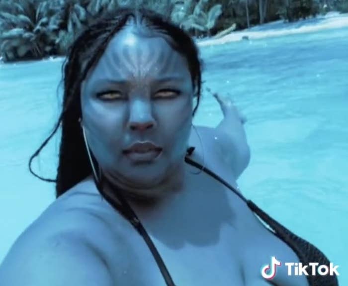 Lizzo in the water with an avatar filter on her face