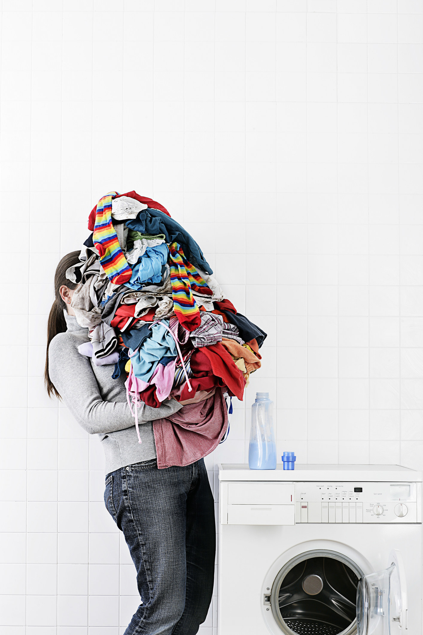 A woman holding a pile of laundry