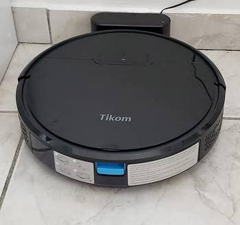 a reviewer photo of the vacuum on a charging dock