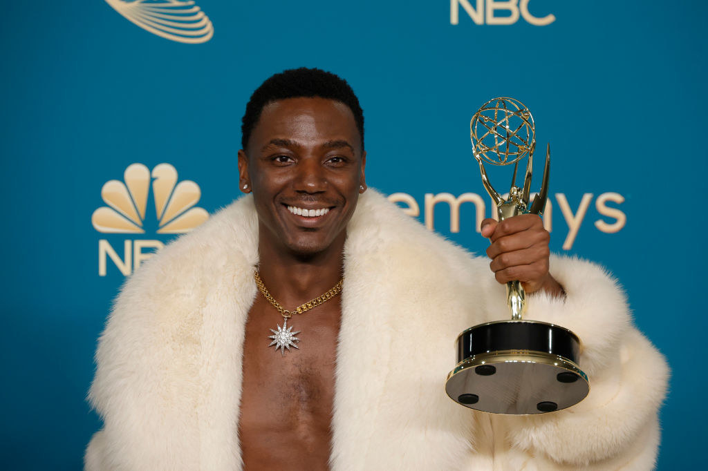 Jerrod smiles as he holds up his Emmy