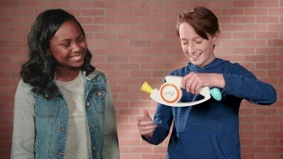 two kids play with a Bop It!