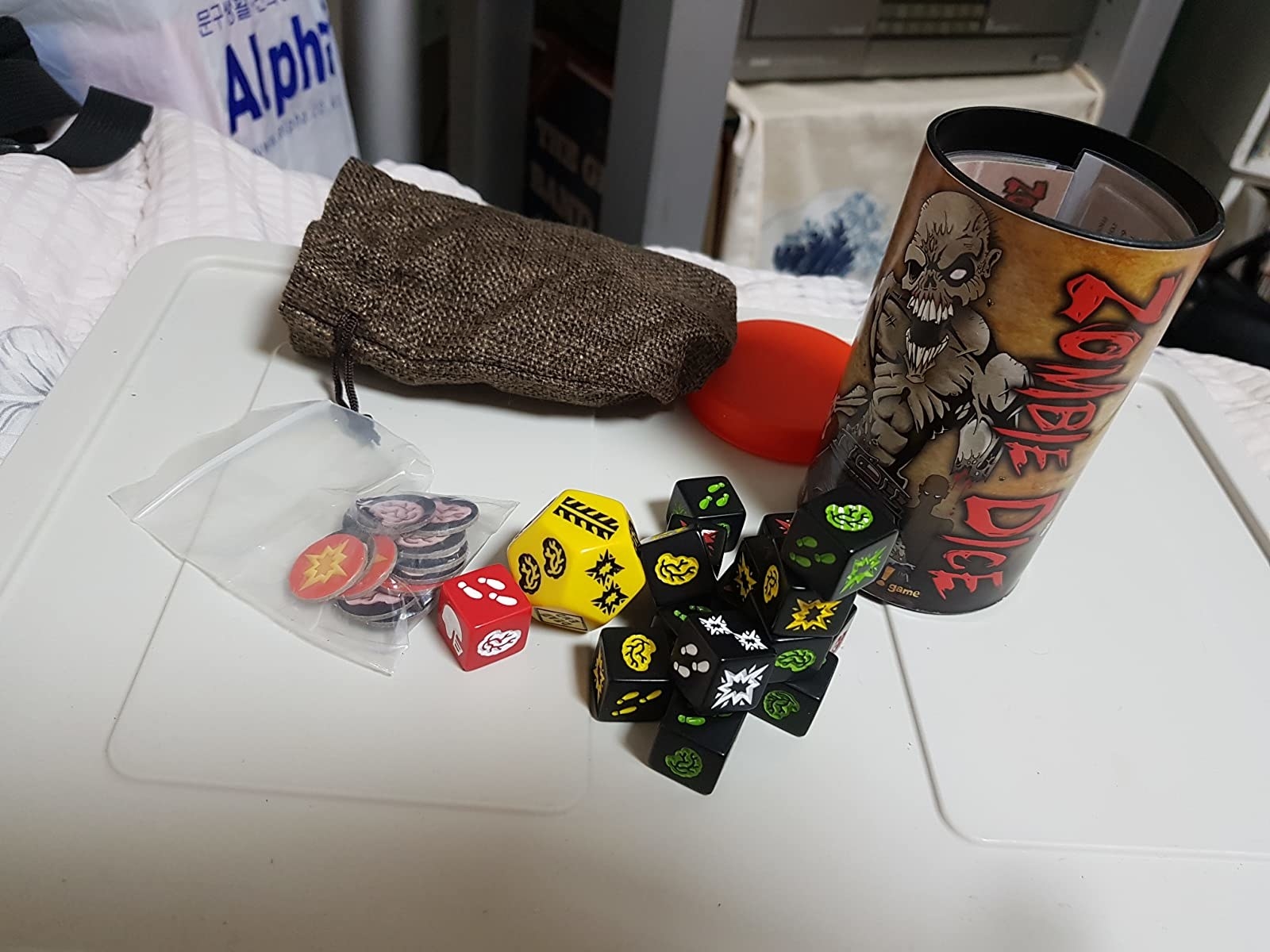Reviewer&#x27;s photo of Zombie Dice with the dice and other game pieces out of the box
