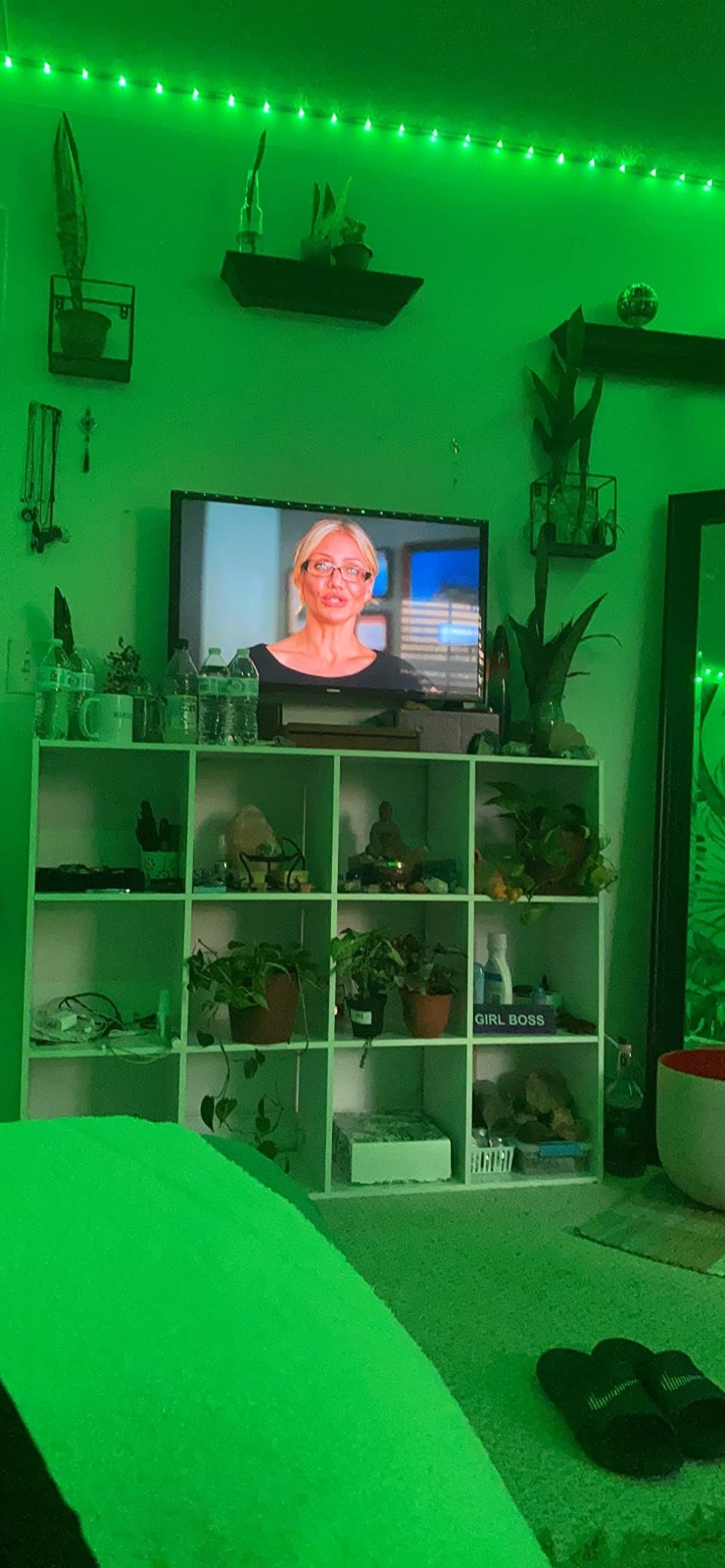 A reviewer's bedroom with cubby shelves and green light