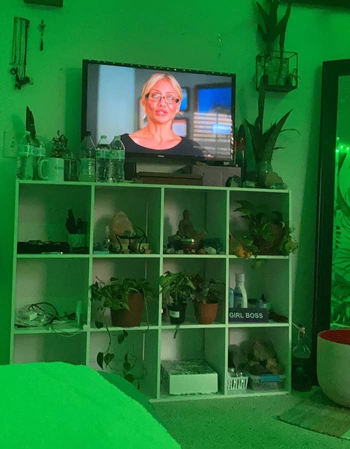 A reviewer&#x27;s bedroom with cubby shelves and green light