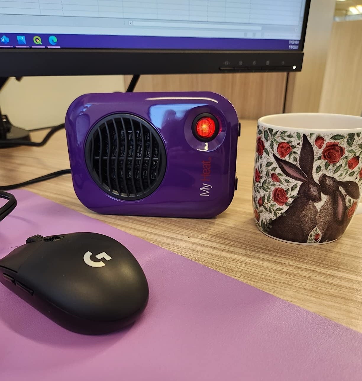 a reviewer photo of the purple heater on their desk