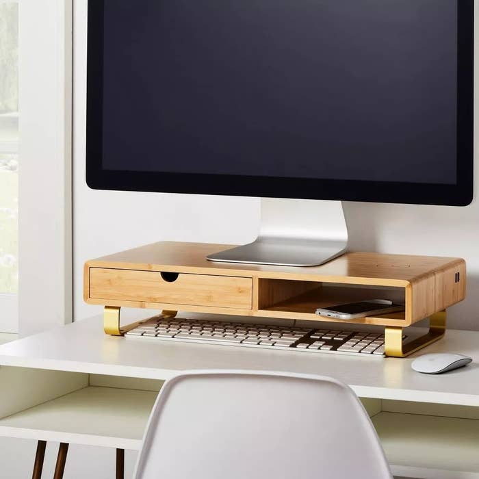 The bamboo organizer on a desk with a monitor on top and a keyboard below