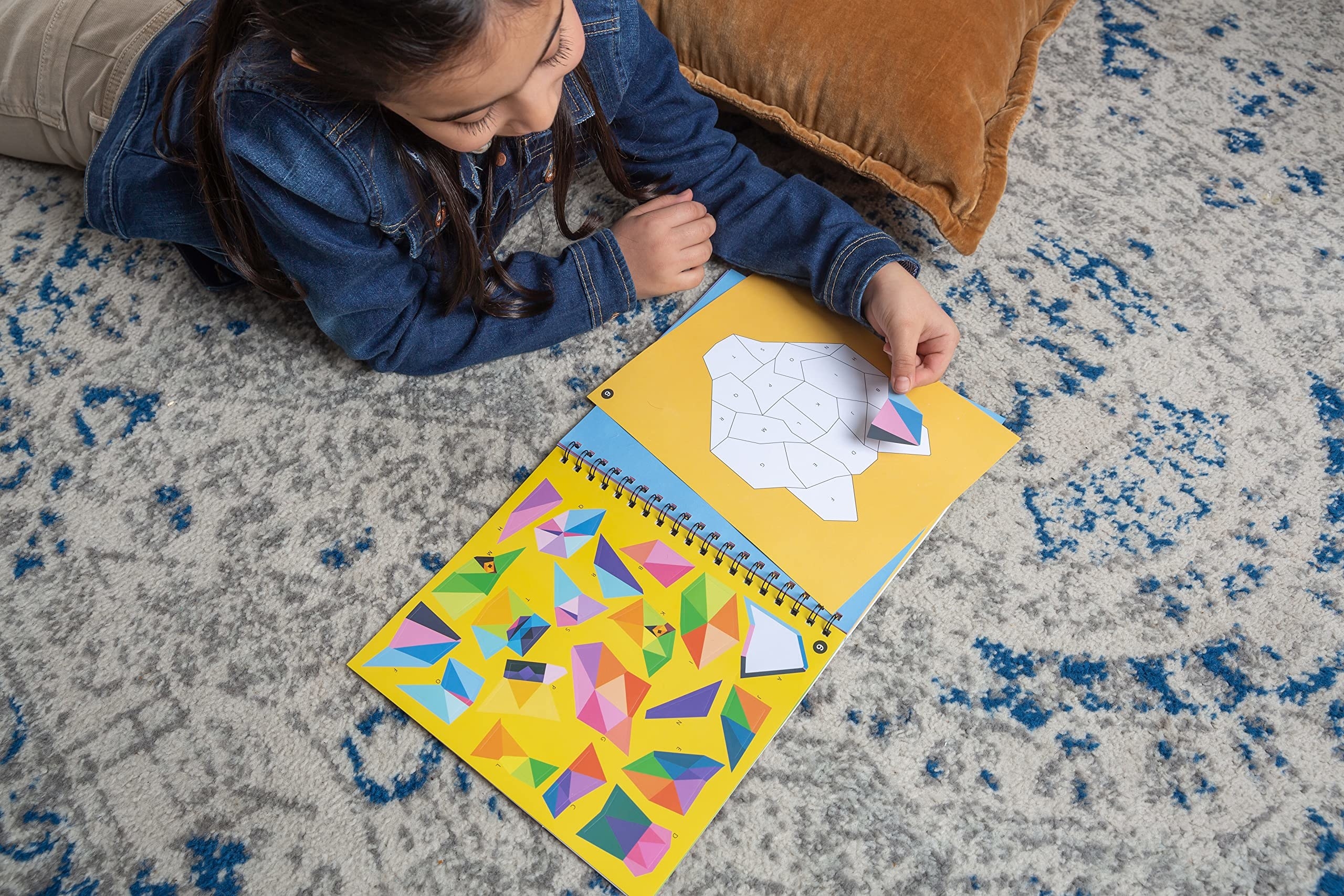 child putting the stickers in the blank image