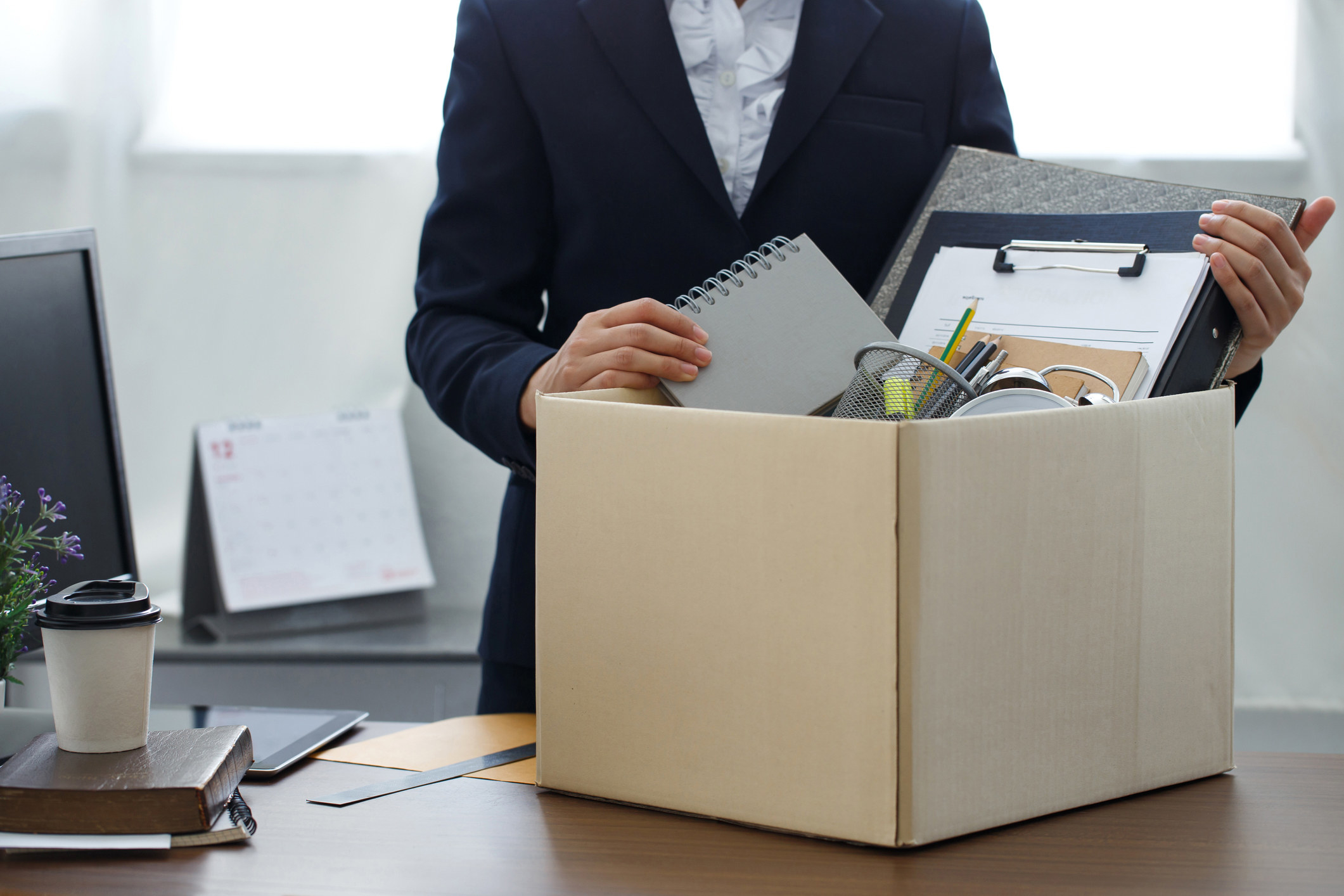 Woman packs her office into a box