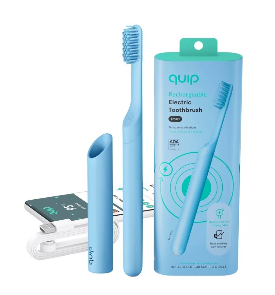 the blue toothbrush, cover, packaging, and the white charging cord and a phone displaying the quip app.