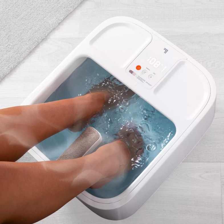 Person with their feet inside foot spa