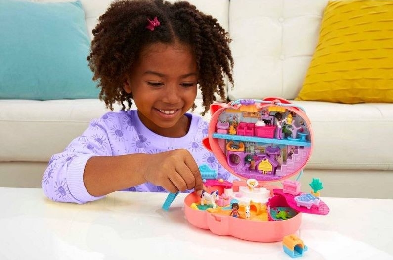 a child plays with the polly pocket