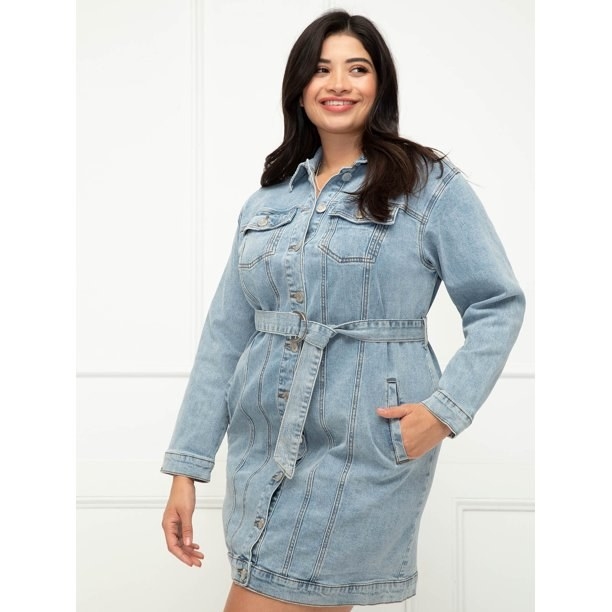 Model wearing light wash long sleeve denim tie dress