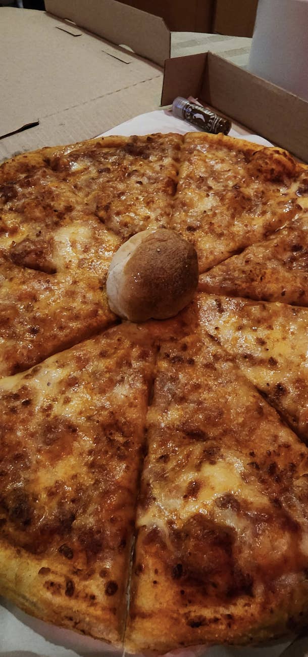A dough ball in the middle of a round pizza pie