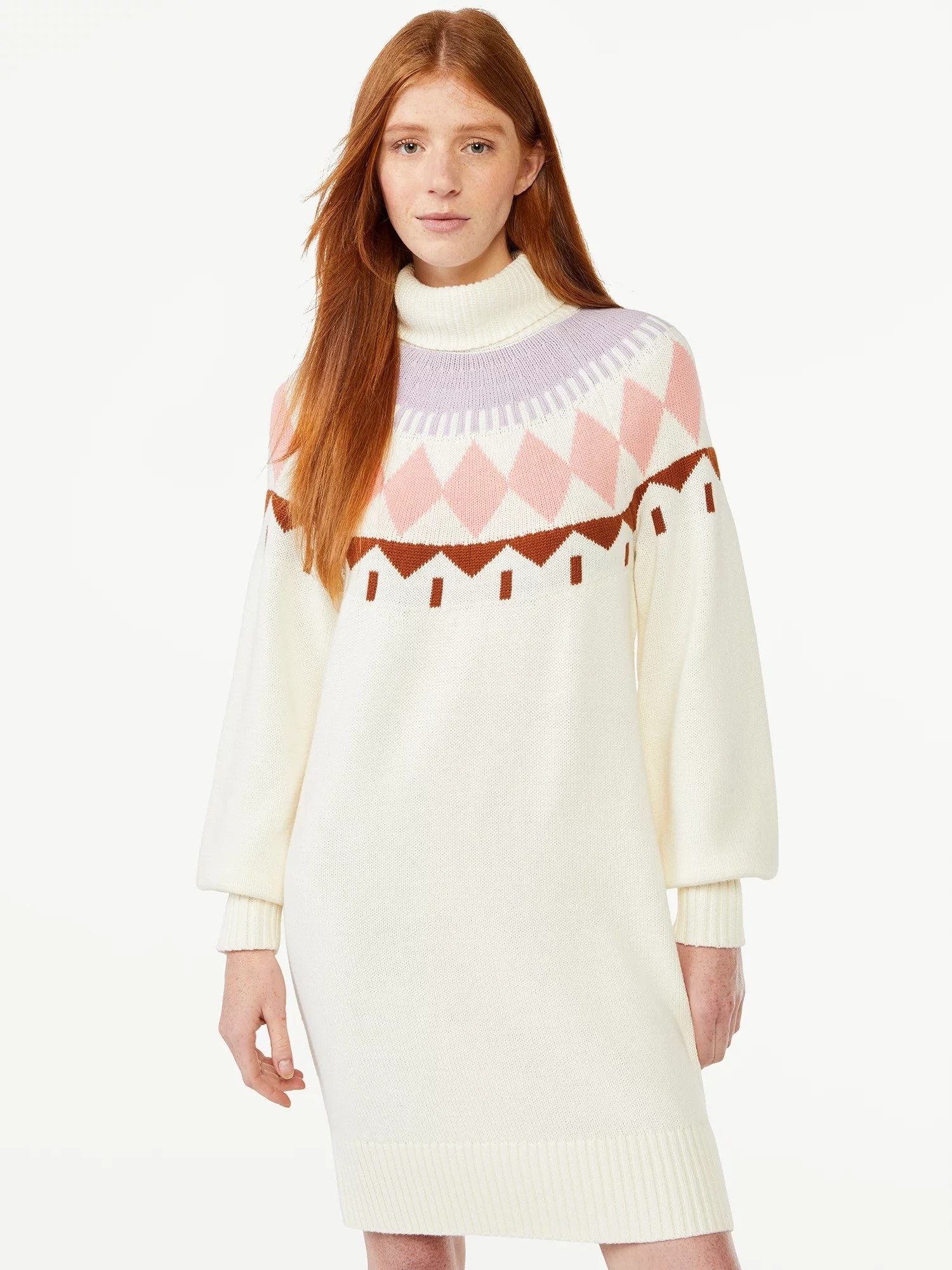 Model wearing white sweater dress with purple, pink, and copper design across chest