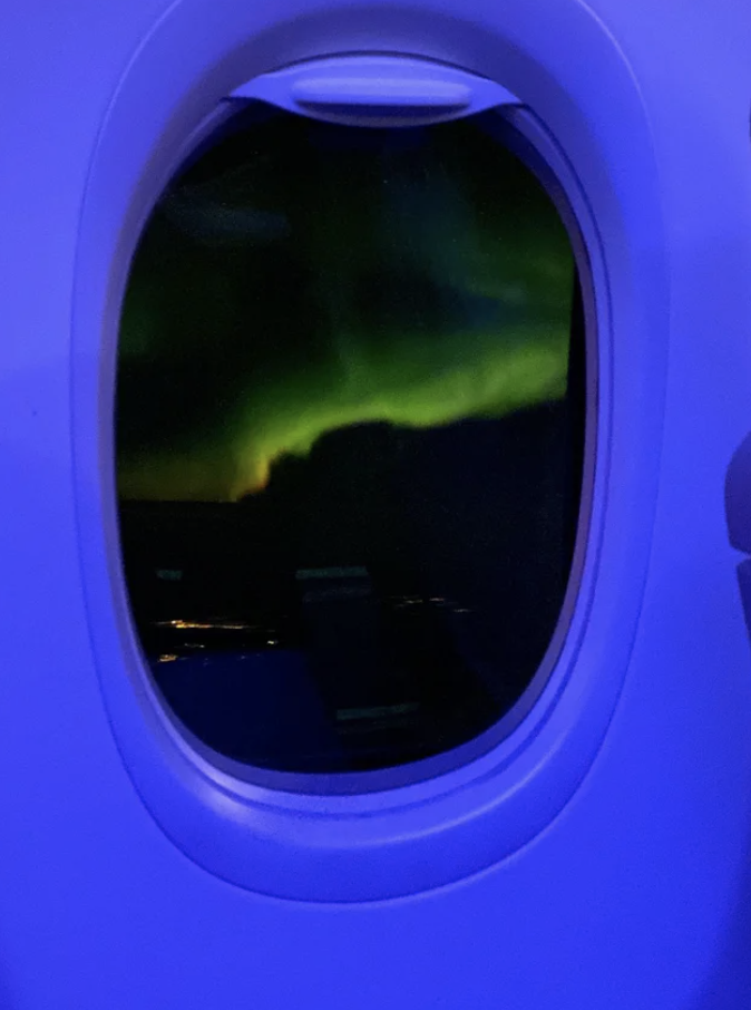 The northern lights through an airplane window