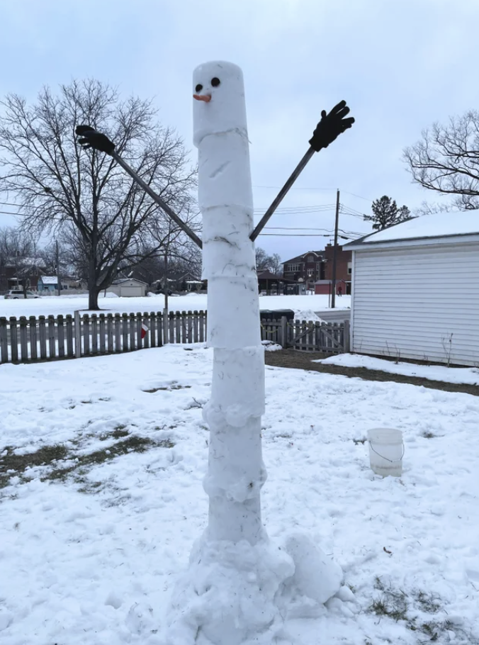 A very tall snowman with arms