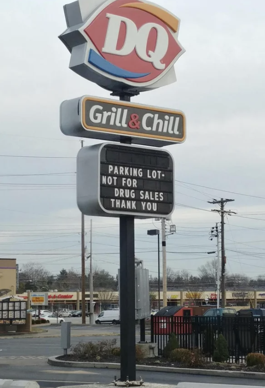 The marquee sign in front of a Dairy Queen says "parking lot not for drug sales, thank you"
