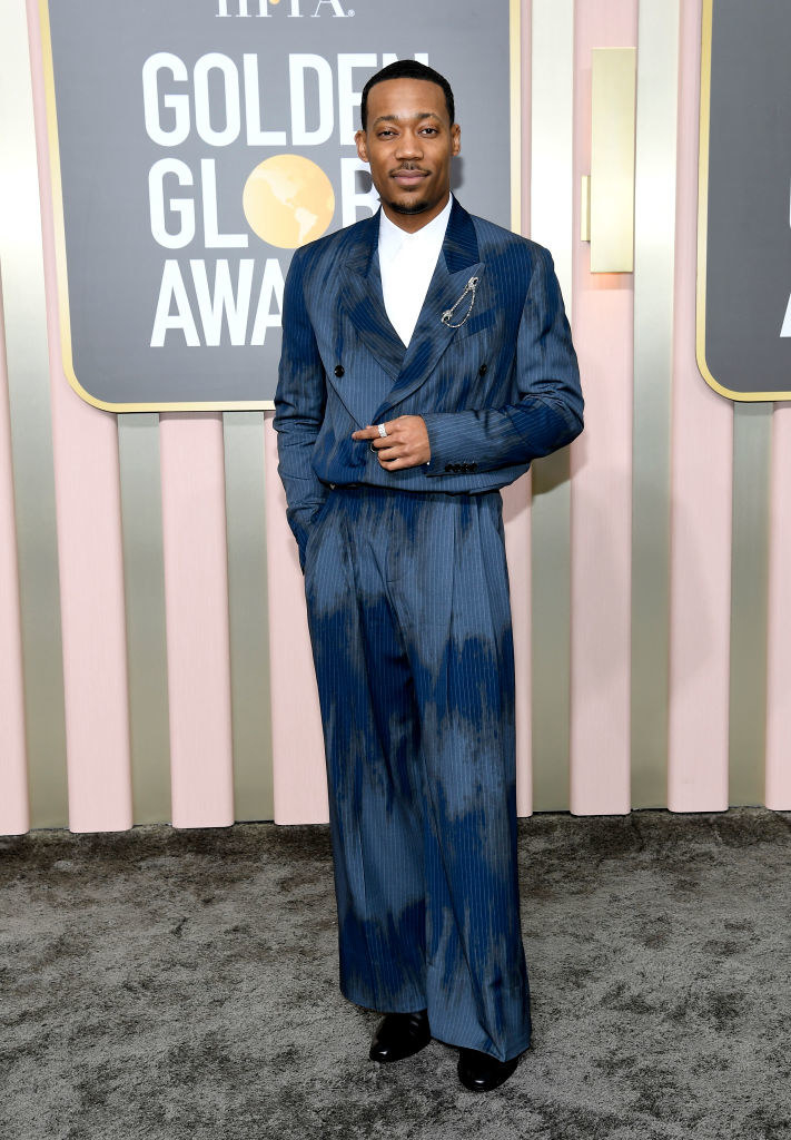 Tyler James Williams arrives at the 80th Annual Golden Globe Awards in a colorful suit