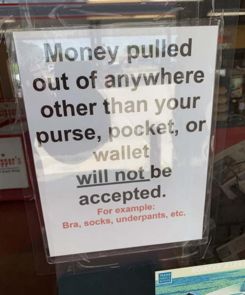 The sign says &quot;money pulled out of anywhere other than your purse, pocket, or wallet will not be accepted; for example: bra, socks, underpants, etc&quot;