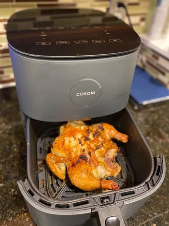 a different reviewer showing a cooked chicken in the gray air fryer