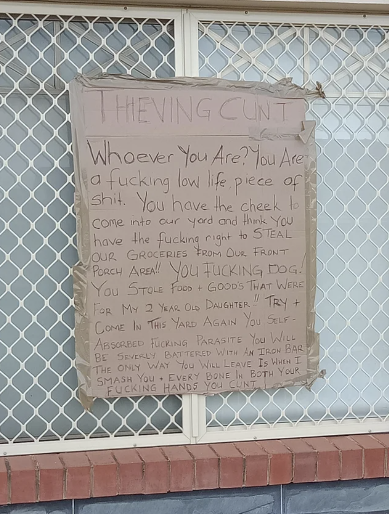 A very long sign calling someone a &quot;lowlife piece of shit&quot; and saying they&#x27;ll beat them with an iron bar for stealing food meant for their 2-year-old daughter