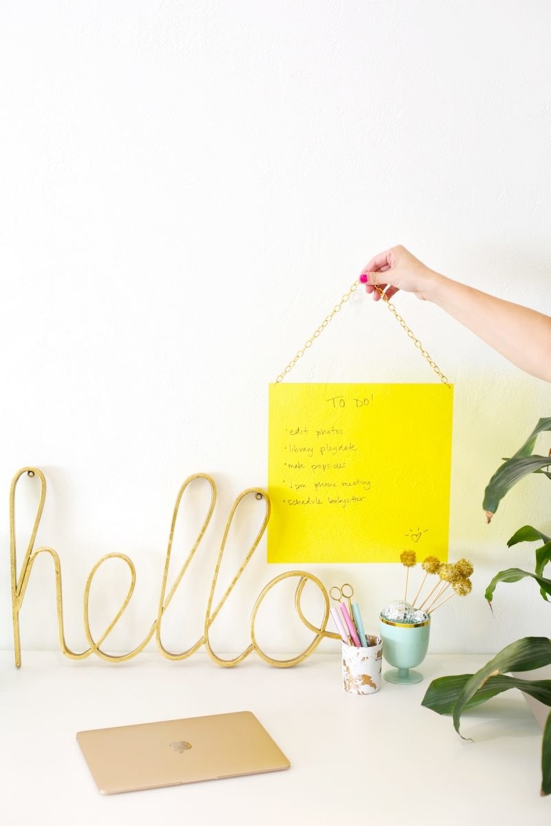 desk with a yellow brainstorm board hanging over it