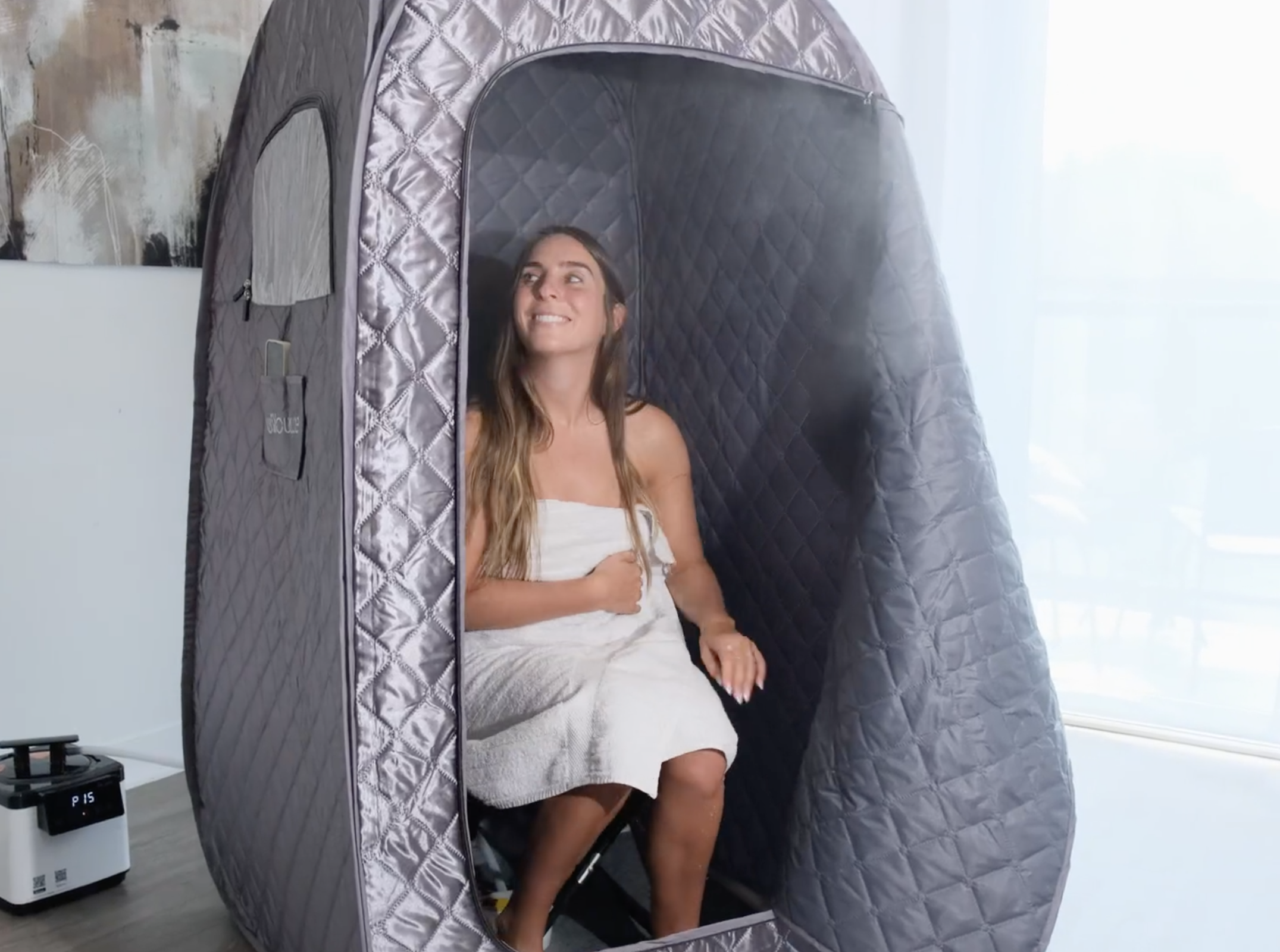 person sitting in the sauna pod