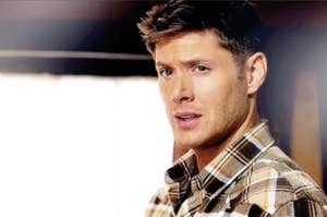dean winchester furrows his brow ever so slightly and his mouth is slightly open