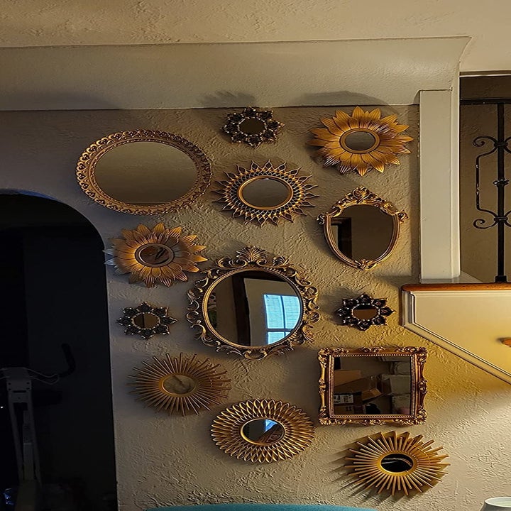 A reviewers wall full of the unique gold mirrors