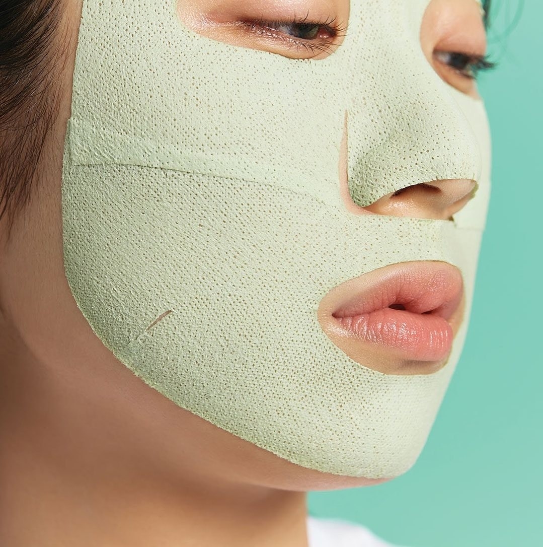 a person wearing the two-part mud mask on their face