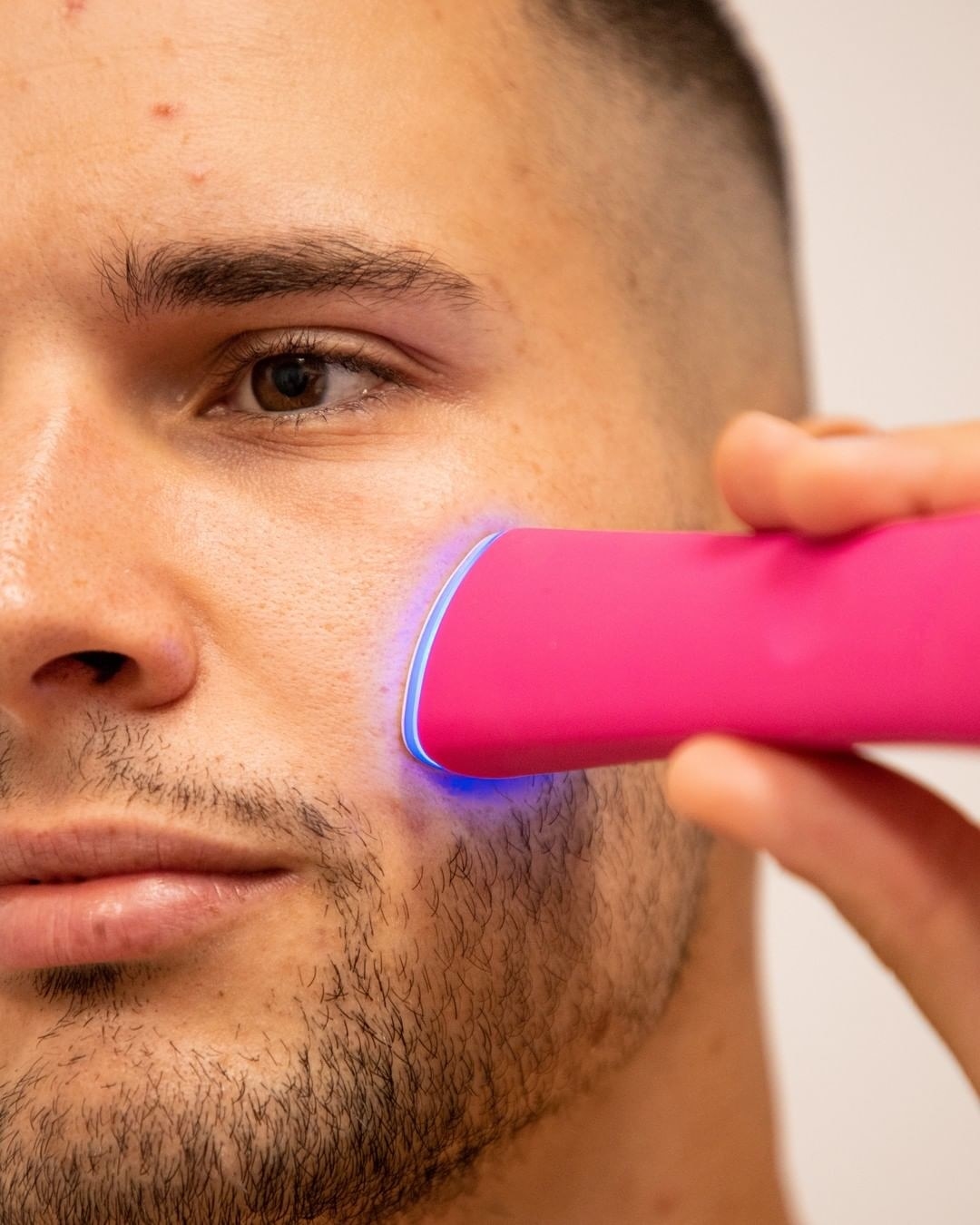 a person using the foreo light wand on their face