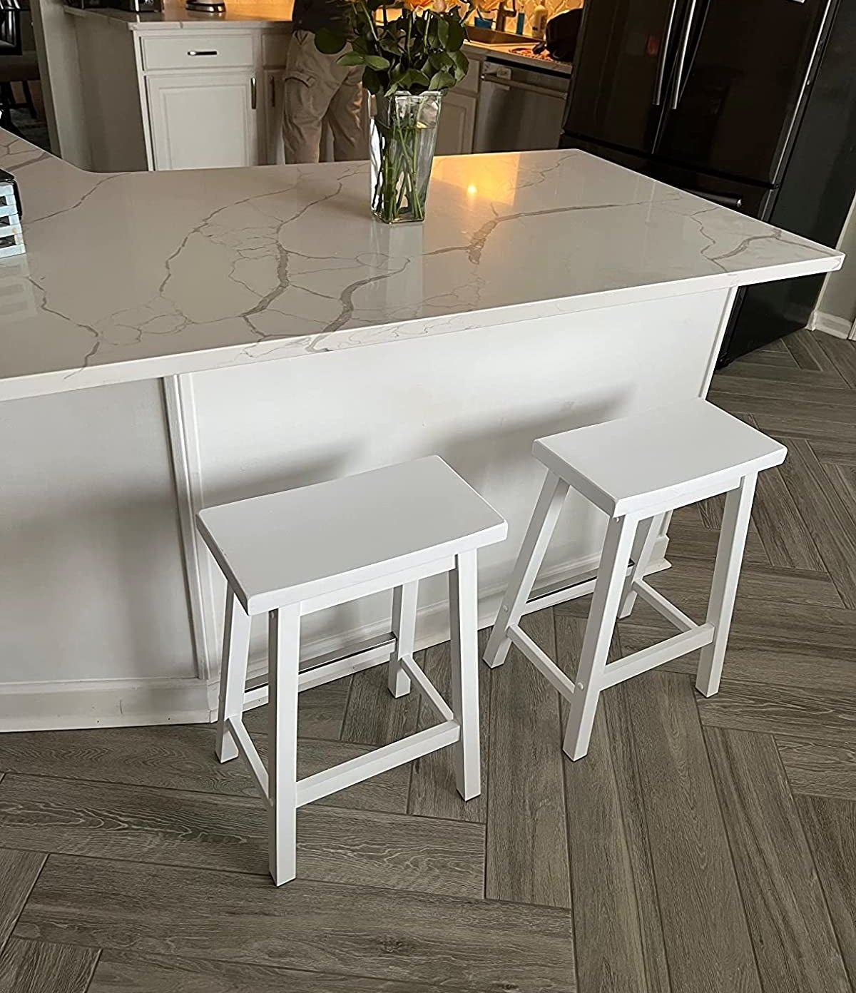 Reviewer image of two white counter stools in their kitchen