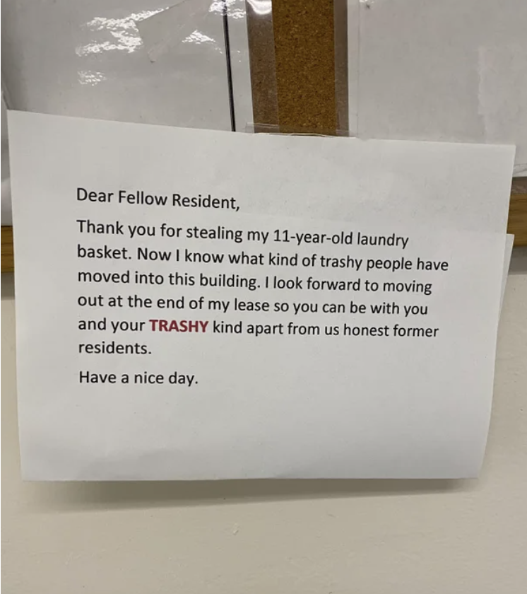 A letter taped to a wall says &quot;dear fellow resident, thank you for stealing my 11-year-old laundry basket, now I know what kind of trashy people have moved into this building&quot;