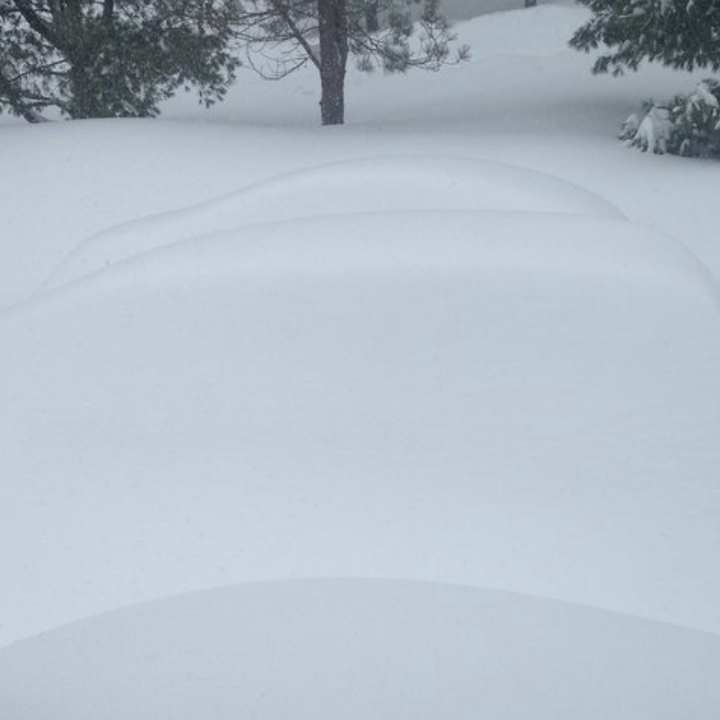 A car completely covered in snow