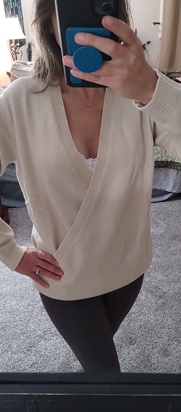 Reviewer wearing beige v-neck sweater