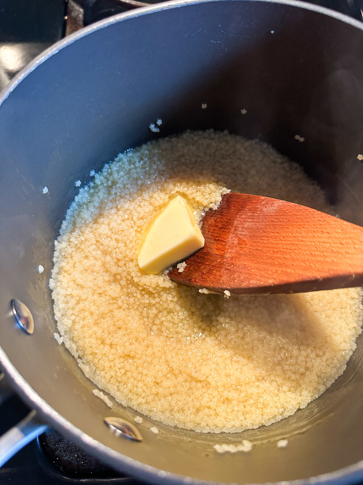 mixing in a knob of butter into the pastina
