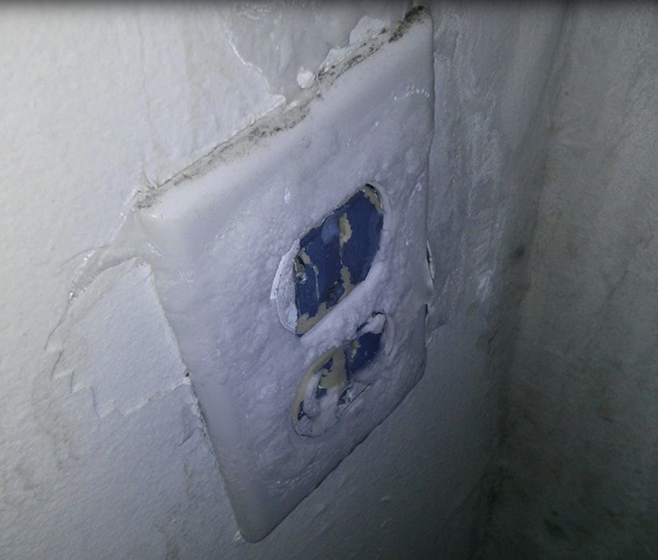 An outlet covered in ice