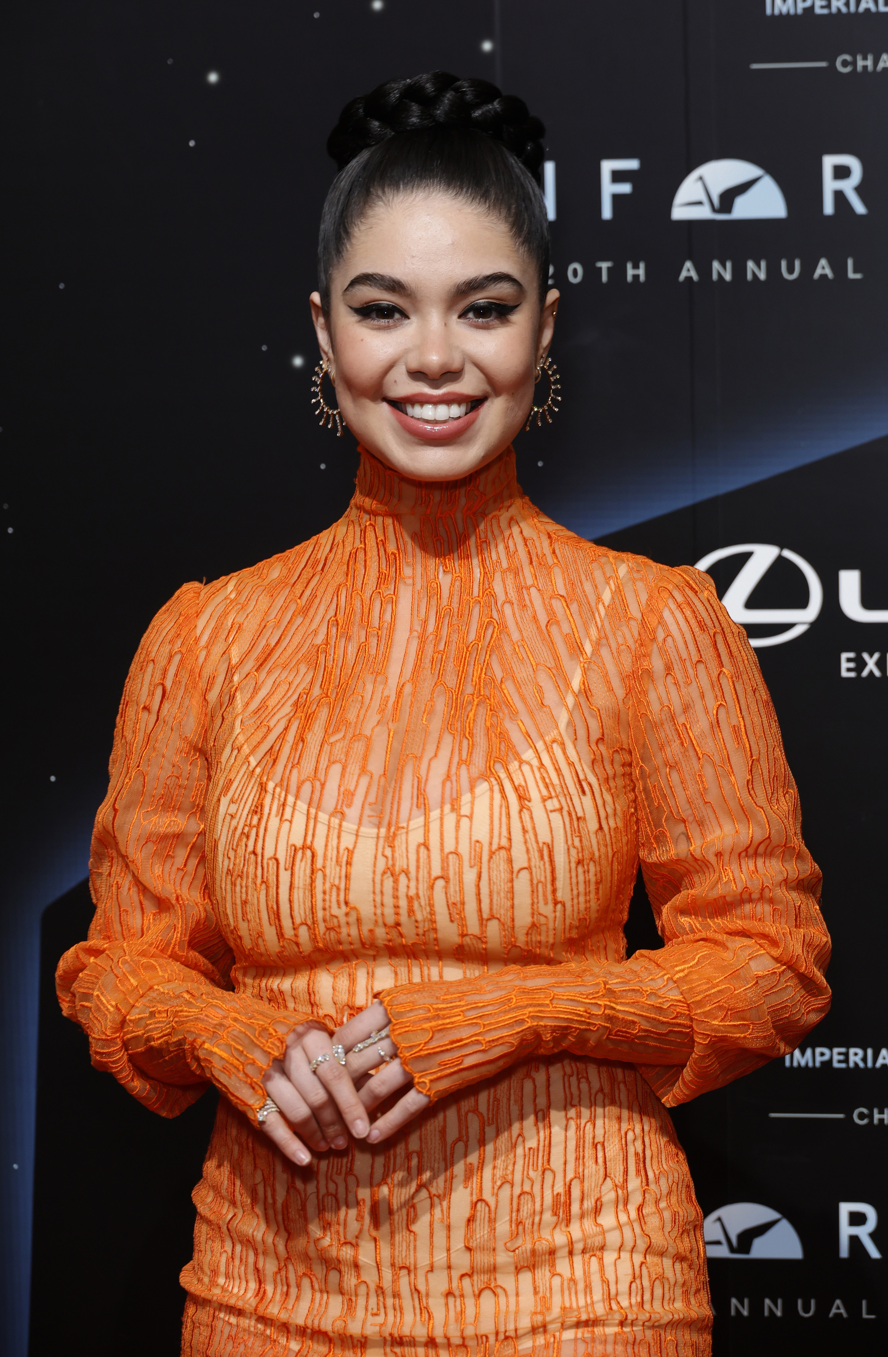 Close-up of Auli&#x27;i on the red carpet in a high-neck, long-sleeved outfit