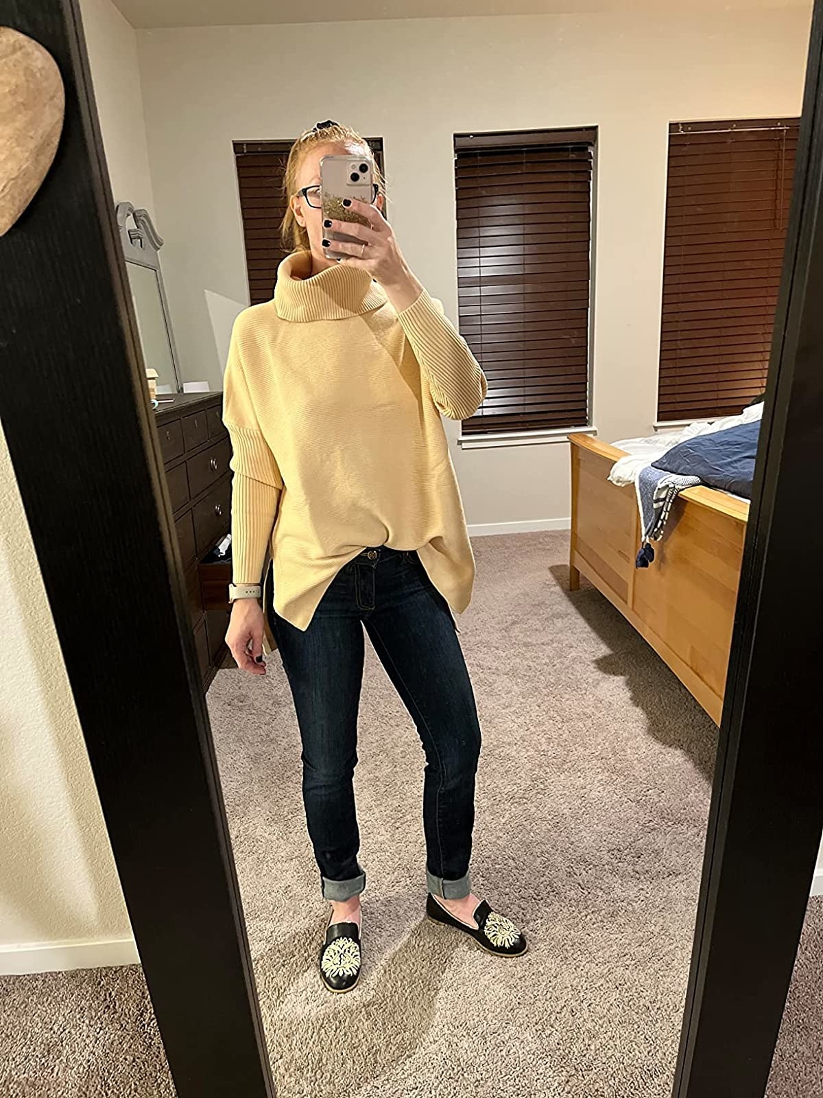 reviewer wearing the sweater in yellow