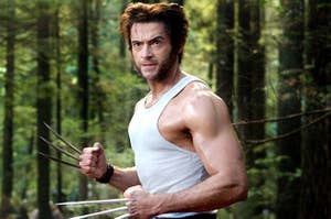 Wolverine poses in the forest flexing his large arm muscles