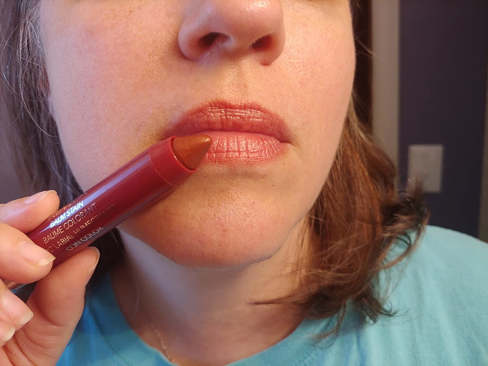 Reviewer holding the adore lip stain