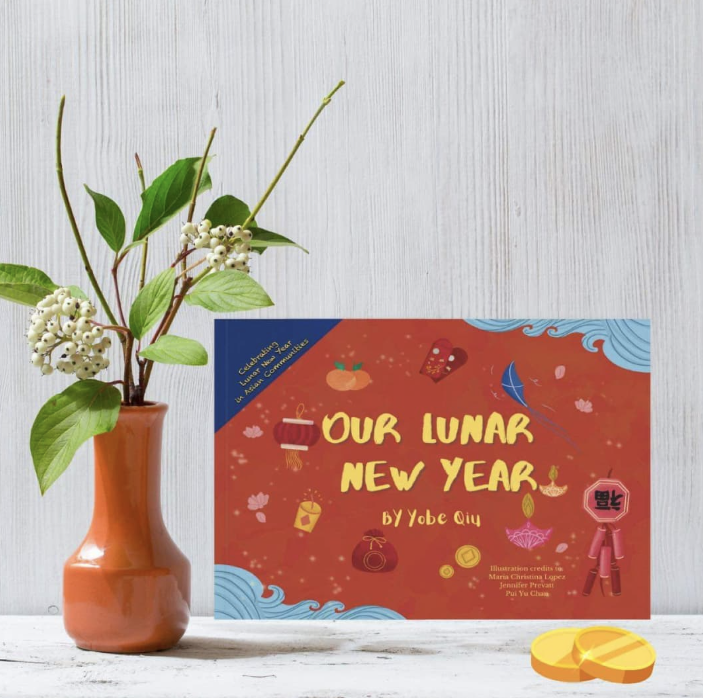 Our Lunar New Year Book on white background next to potted plant